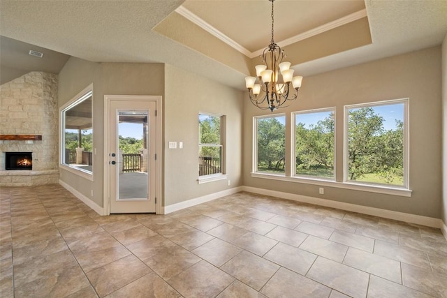 306 Anns Way, Blanco, TX 78606 - unfurnished dining area with healthy amount of natural light, a chandelier, a stone fireplace, and ornamental molding
