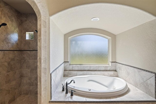 306 Anns Way, Blanco, TX 78606 - bathroom with a tile shower, a garden tub, and a textured wall