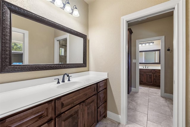 306 Anns Way, Blanco, TX 78606 - bathroom featuring vanity, tile patterned flooring, and a textured wall