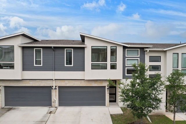 2050 Lohmans Spur Rd Unit 802, Lakeway, TX 78734 - view of front of property with stucco siding, driveway, and an attached garage