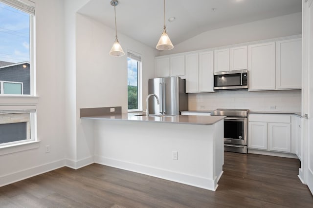 2050 Lohmans Spur Rd Unit 802, Lakeway, TX 78734 - kitchen featuring stainless steel appliances, decorative backsplash, white cabinets, dark wood-style flooring, and hanging light fixtures