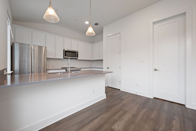 2050 Lohmans Spur Rd Unit 802, Lakeway, TX 78734 - kitchen with appliances with stainless steel finishes, dark wood-style flooring, backsplash, white cabinetry, and hanging light fixtures