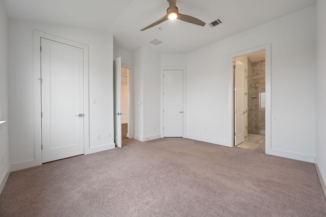 2050 Lohmans Spur Rd Unit 802, Lakeway, TX 78734 - unfurnished bedroom with carpet, ensuite bath, and a ceiling fan