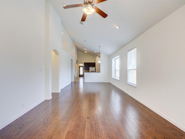 11600 Yeadon Way, Austin, TX 78717 - unfurnished living room featuring a ceiling fan, dark wood finished floors, arched walkways, and high vaulted ceiling