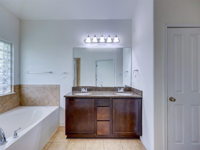 11600 Yeadon Way, Austin, TX 78717 - bathroom featuring a garden tub, double vanity, and tile patterned flooring