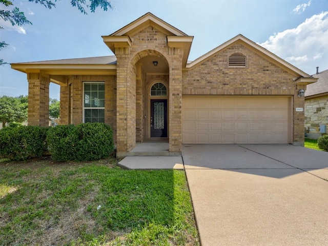 11600 Yeadon Way, Austin, TX 78717 - view of front of house featuring an attached garage, concrete driveway, and brick siding