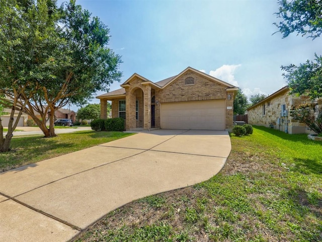 11600 Yeadon Way, Austin, TX 78717 - view of front facade featuring brick siding, a garage, concrete driveway, and a front yard