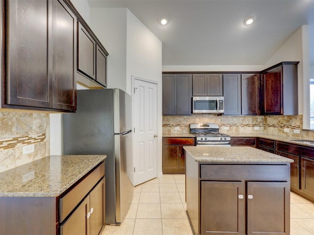 11600 Yeadon Way, Austin, TX 78717 - kitchen with appliances with stainless steel finishes, tasteful backsplash, light stone counters, a center island, and recessed lighting