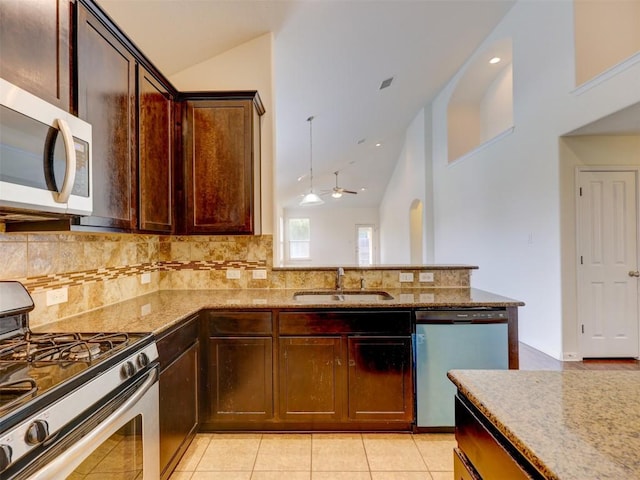 11600 Yeadon Way, Austin, TX 78717 - kitchen with appliances with stainless steel finishes, light stone counters, tasteful backsplash, ceiling fan, and high vaulted ceiling