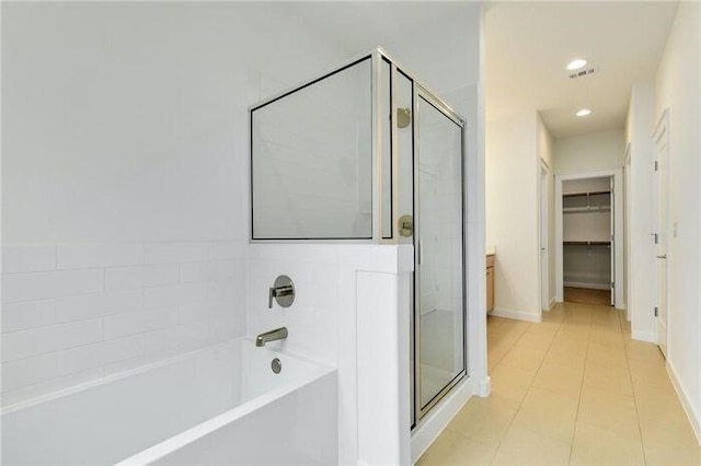 6800 Menchaca Rd Unit 45, Austin, TX 78745 - bathroom featuring a shower stall, a garden tub, a walk in closet, tile patterned floors, and recessed lighting
