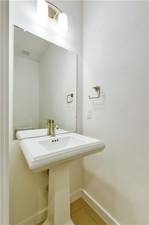 6800 Menchaca Rd Unit 45, Austin, TX 78745 - bathroom featuring baseboards and tile patterned flooring
