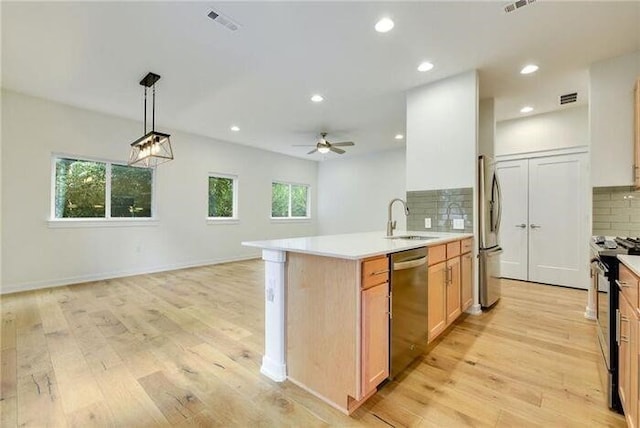 6800 Menchaca Rd Unit 45, Austin, TX 78745 - kitchen with appliances with stainless steel finishes, light wood-type flooring, decorative backsplash, light countertops, and recessed lighting