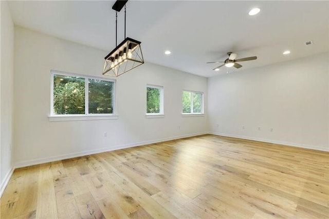 6800 Menchaca Rd Unit 45, Austin, TX 78745 - spare room with light wood-type flooring, ceiling fan, recessed lighting, and a chandelier