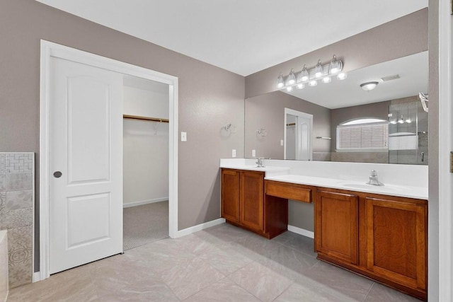 1532 Homewood Cir, Round Rock, TX 78665 - bathroom with double vanity, tiled shower, tile patterned flooring, and a spacious closet
