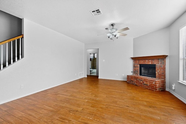 1532 Homewood Cir, Round Rock, TX 78665 - unfurnished living room featuring wood finished floors, ceiling fan, and a fireplace