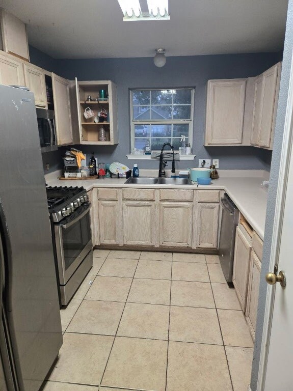 1608 Peridot Rd, Pflugerville, TX 78660 - kitchen featuring stainless steel appliances, light tile patterned floors, light countertops, and open shelves