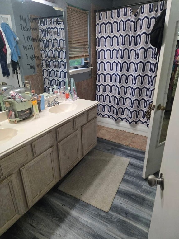 1608 Peridot Rd, Pflugerville, TX 78660 - bathroom with double vanity, shower / tub combo, and wood finished floors