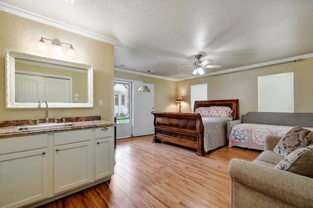 260 N Santa Clara Ave, New Braunfels, TX 78130 - bedroom with crown molding, a textured ceiling, light wood-style flooring, and a ceiling fan