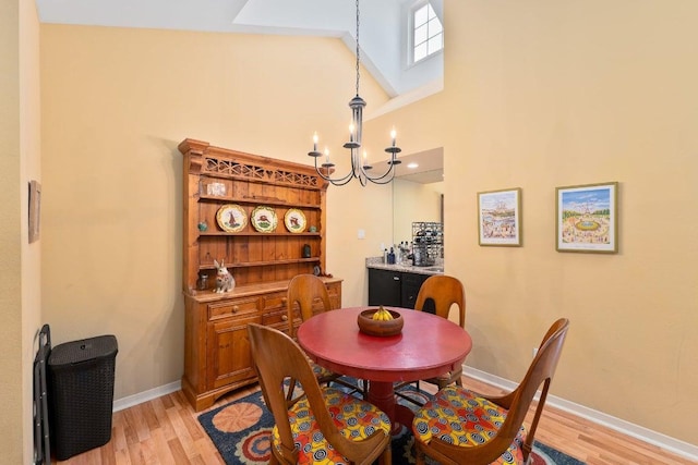 3200 Duval St Unit 309, Austin, TX 78705 - dining area with light wood-type flooring, a chandelier, and a towering ceiling