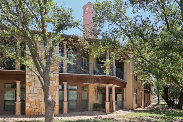 300 San Gabriel Village Blvd Unit 423, Georgetown, TX 78626 - rear view of property featuring a balcony and stone siding