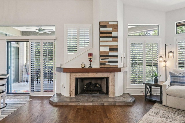 300 San Gabriel Village Blvd Unit 423, Georgetown, TX 78626 - living area featuring a ceiling fan, wood finished floors, healthy amount of natural light, a fireplace, and a towering ceiling