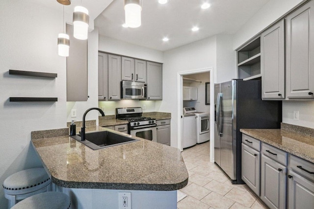 300 San Gabriel Village Blvd Unit 423, Georgetown, TX 78626 - kitchen with open shelves, stainless steel appliances, gray cabinetry, washer and dryer, and recessed lighting