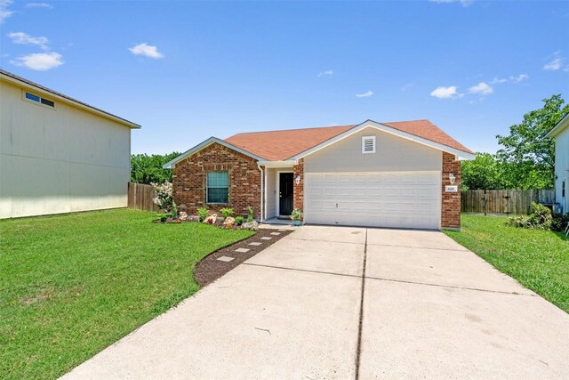620 Lavaca Loop, Elgin, TX 78621 - view of front of property featuring brick siding, a garage, and driveway