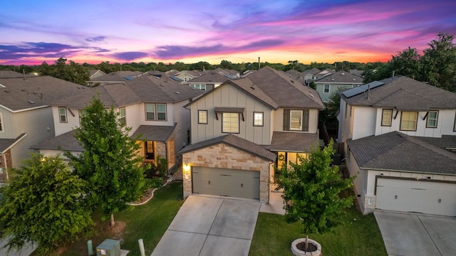 1207 Diggy Dr, Austin, TX 78748 - view of front of property with board and batten siding, a residential view, concrete driveway, stone siding, and a yard