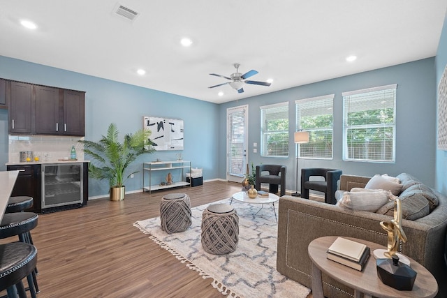 1207 Diggy Dr, Austin, TX 78748 - living area featuring beverage cooler, wood finished floors, recessed lighting, ceiling fan, and bar