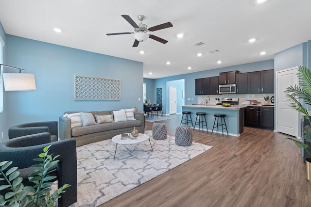 1207 Diggy Dr, Austin, TX 78748 - living room featuring wood finished floors, a ceiling fan, and recessed lighting