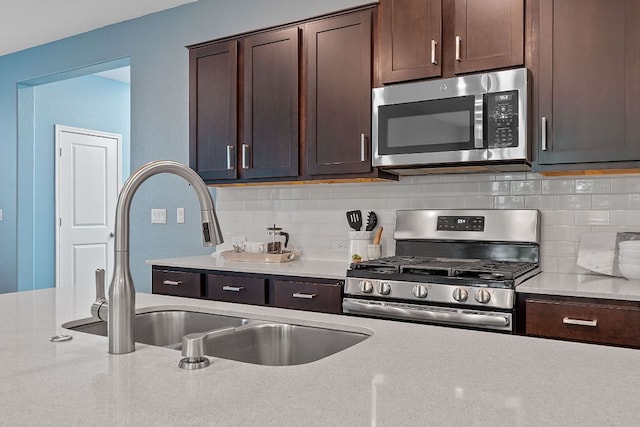 1207 Diggy Dr, Austin, TX 78748 - kitchen featuring stainless steel appliances, dark brown cabinets, and backsplash