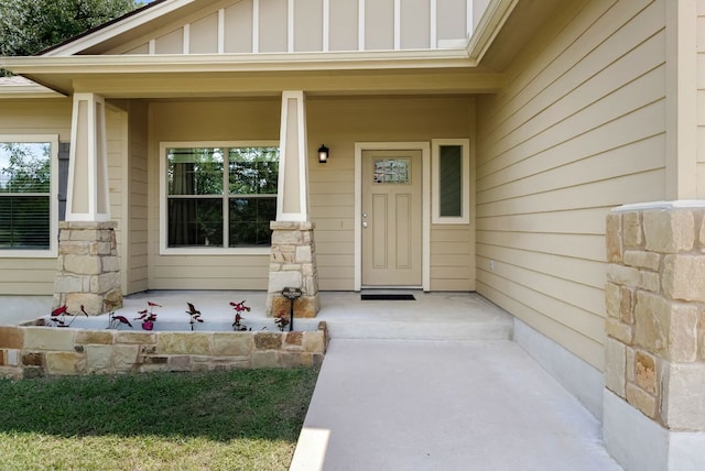 14601 Running Deer Trl, Austin, TX 78734 - entrance to property featuring covered porch, board and batten siding, and stone siding