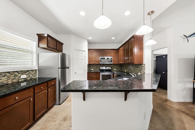 14601 Running Deer Trl, Austin, TX 78734 - kitchen with appliances with stainless steel finishes, tasteful backsplash, a peninsula, a kitchen bar, and hanging light fixtures