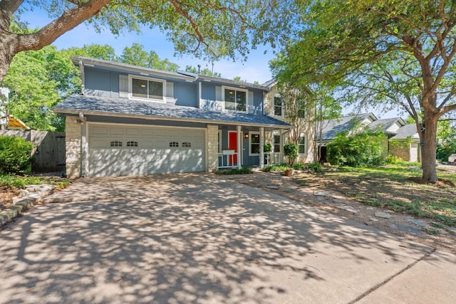 8206 Avocet Dr, Austin, TX 78745 - view of front of house featuring concrete driveway, an attached garage, stone siding, covered porch, and board and batten siding