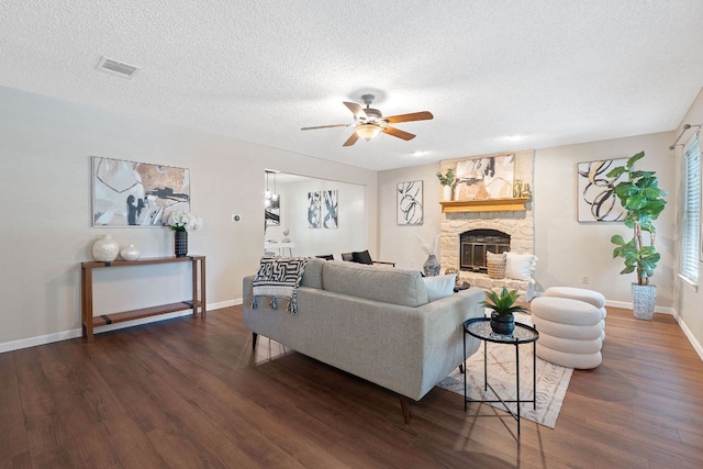 8206 Avocet Dr, Austin, TX 78745 - living area with a ceiling fan, wood finished floors, a textured ceiling, and a fireplace