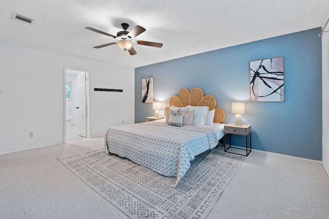8206 Avocet Dr, Austin, TX 78745 - carpeted bedroom featuring a textured ceiling, a ceiling fan, and connected bathroom
