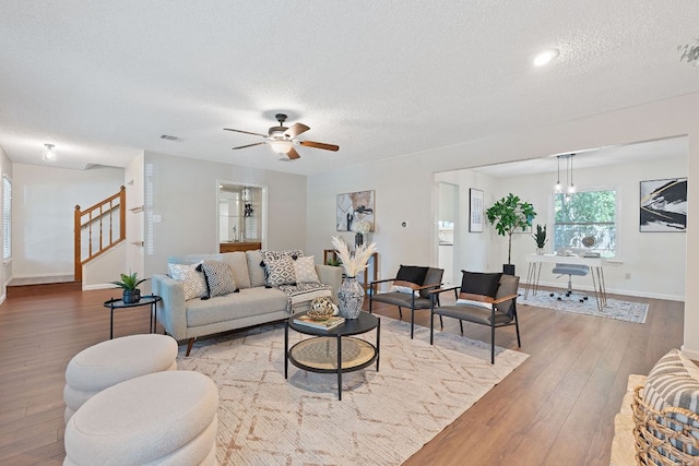8206 Avocet Dr, Austin, TX 78745 - living area with wood finished floors, a textured ceiling, stairs, and a ceiling fan