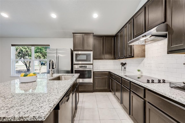 1901 Owens Ln, Lago Vista, TX 78645 - kitchen featuring appliances with stainless steel finishes, under cabinet range hood, dark brown cabinetry, light stone countertops, and recessed lighting