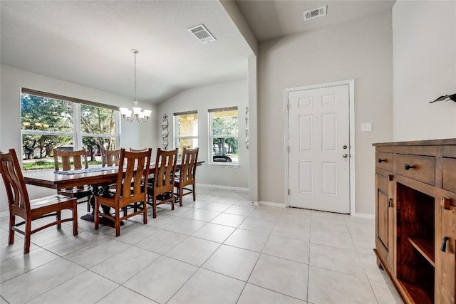 1901 Owens Ln, Lago Vista, TX 78645 - dining room featuring healthy amount of natural light, a chandelier, vaulted ceiling, and light tile patterned floors