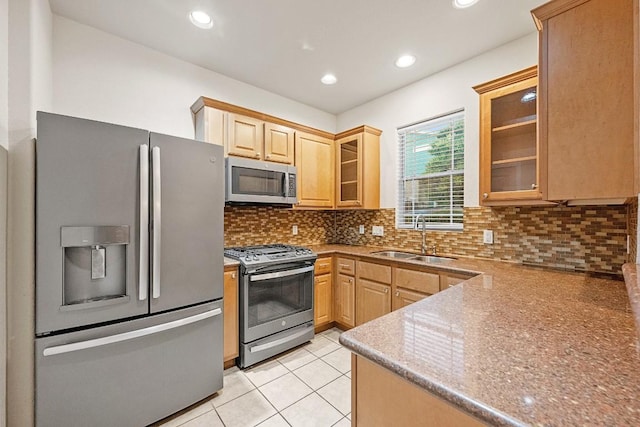 1900 Tramson Dr Unit 94C, Austin, TX 78741 - kitchen with appliances with stainless steel finishes, glass insert cabinets, backsplash, light brown cabinetry, and recessed lighting