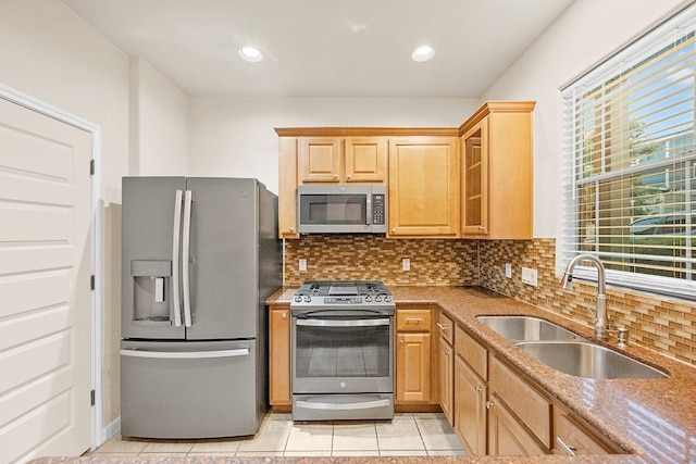 1900 Tramson Dr Unit 94C, Austin, TX 78741 - kitchen with appliances with stainless steel finishes, decorative backsplash, light tile patterned floors, glass insert cabinets, and recessed lighting