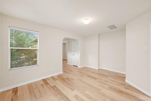 1900 Tramson Dr Unit 94C, Austin, TX 78741 - spare room featuring arched walkways and light wood finished floors