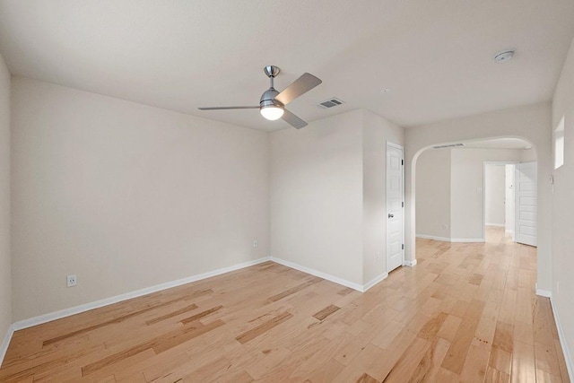 1900 Tramson Dr Unit 94C, Austin, TX 78741 - spare room with light wood-type flooring, a ceiling fan, a smoke detector, and arched walkways