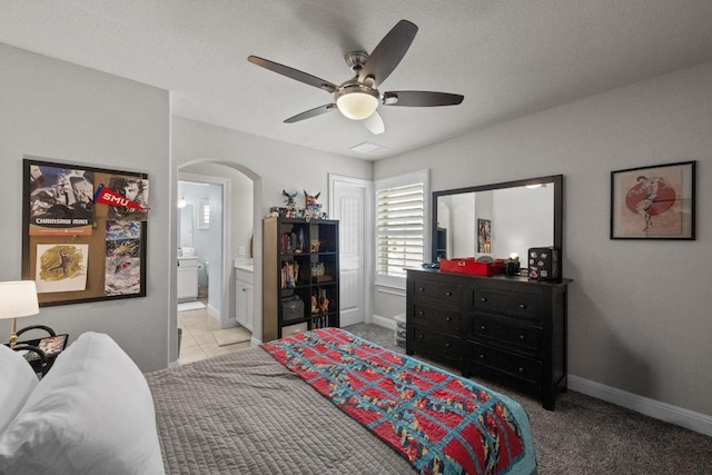 15913 Villa Frontera Dr, Bee Cave, TX 78738 - bedroom with arched walkways, connected bathroom, and ceiling fan