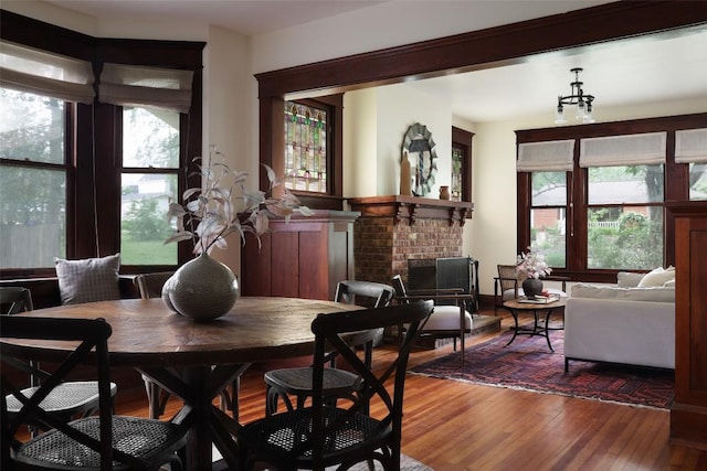 1917 Miles Ave, Austin, TX 78745 - dining area with hardwood / wood-style flooring and a fireplace