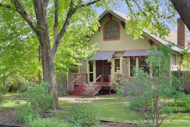 1917 Miles Ave, Austin, TX 78745 - view of front of home featuring a chimney, roof with shingles, and a front lawn