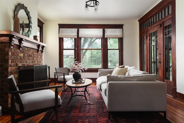 1917 Miles Ave, Austin, TX 78745 - living room featuring wood finished floors and a brick fireplace