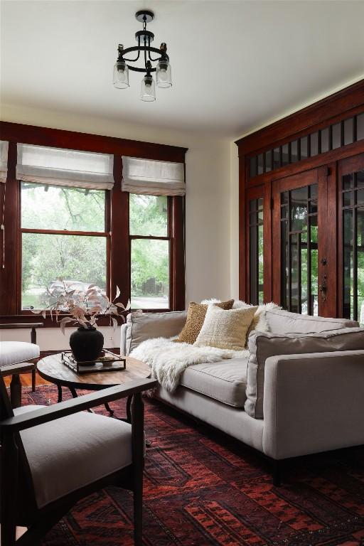 1917 Miles Ave, Austin, TX 78745 - living room with healthy amount of natural light and a chandelier