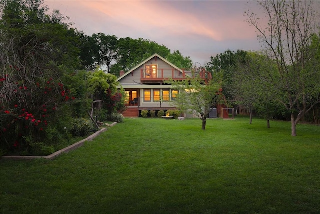 1917 Miles Ave, Austin, TX 78745 - back of house at dusk featuring a yard and covered porch