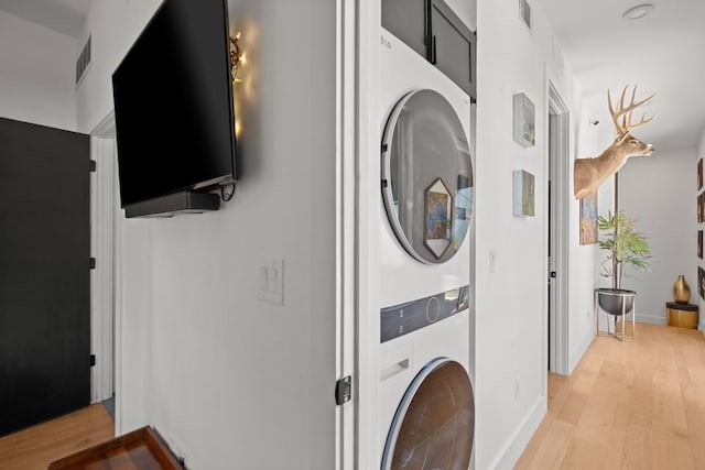 4802 Gladeview Dr Unit 2, Austin, TX 78745 - laundry area with stacked washer / dryer and light wood-style flooring